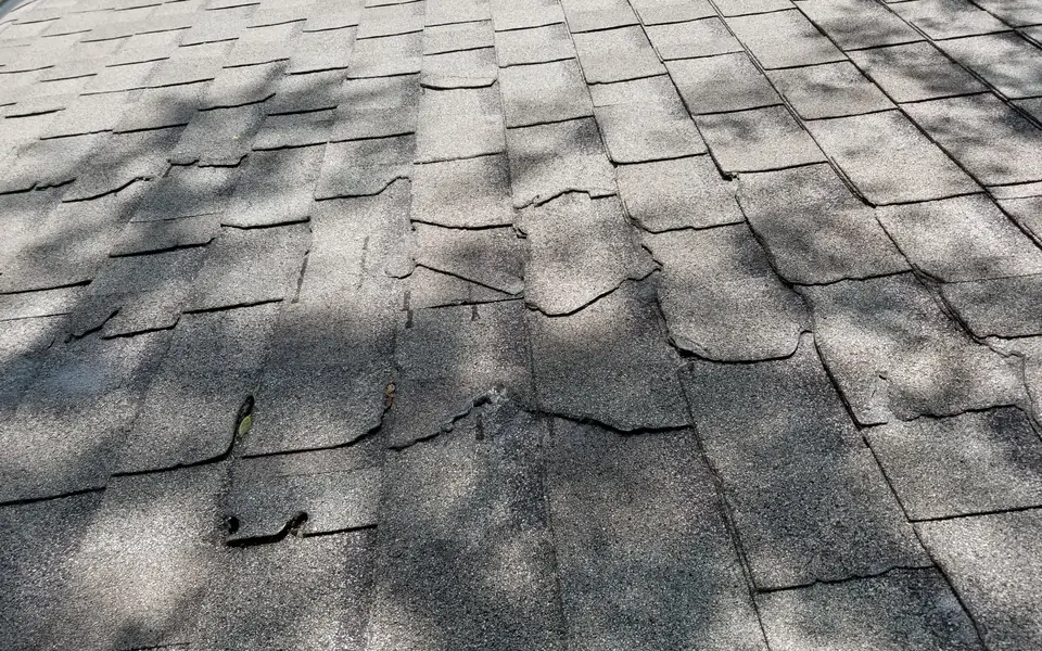 Close-up of worn and damaged asphalt shingles